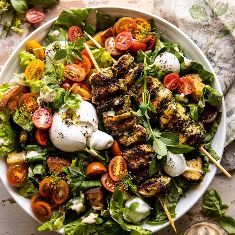 Pesto chicken caesar salad with tomatoes and burrata from Half Baked Harvest