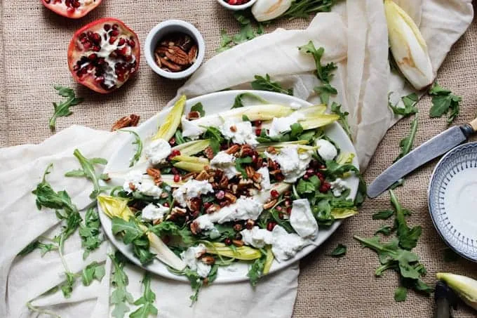 Arugula salad with endive, mozzarella, pecans and pomegranate seeds