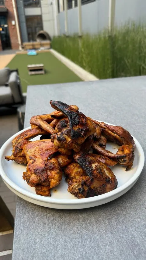 Grilled wings tossed in some epis butter 🇭🇹🔥